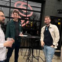 Four alumni chat outside